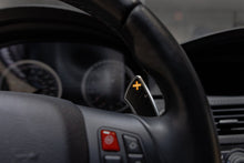 Load image into Gallery viewer, Storm Motorwerks Illuminated Extended Steering Wheel Paddle Shifters for BMW E90 E92 E93 M3 DCT (E9X) - CNC Billet Aluminium with Carbon Fibre Inlay - Self-Powered Glow - Black or Silver Anodised

